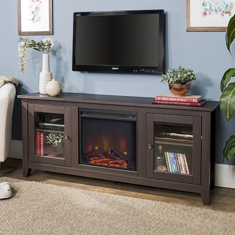 A tv stand with a fireplace included in brown.