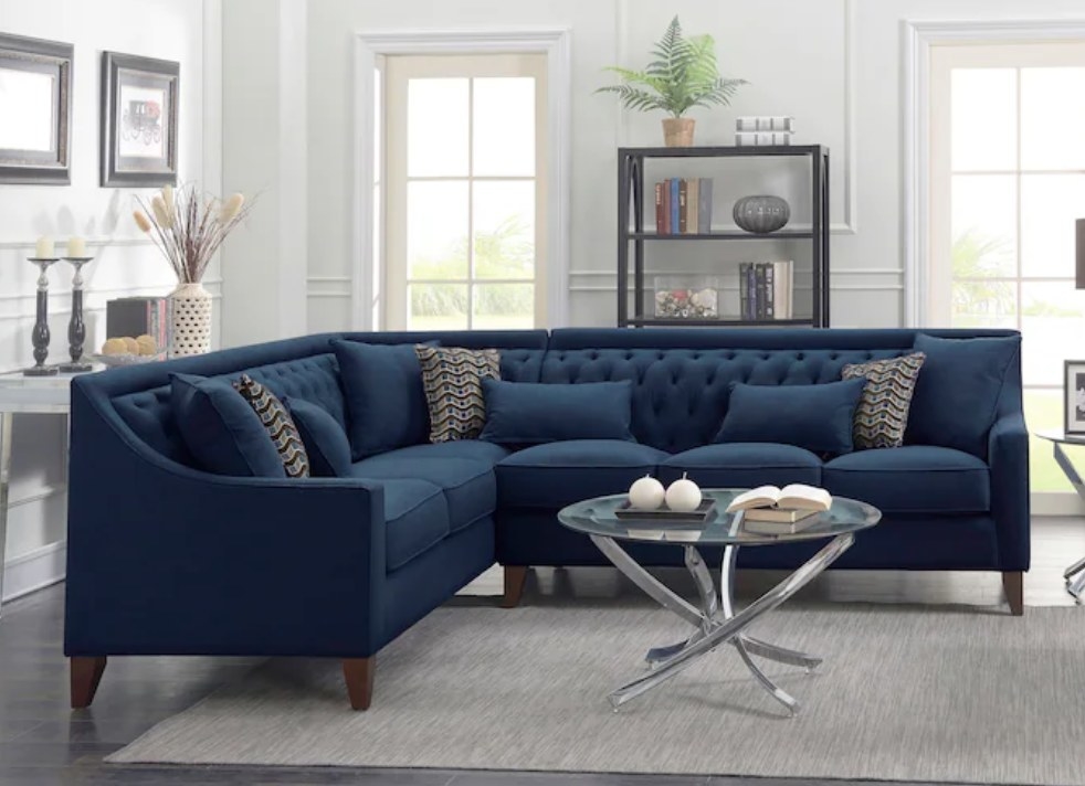 A navy upholstered sectional sofa in a living room