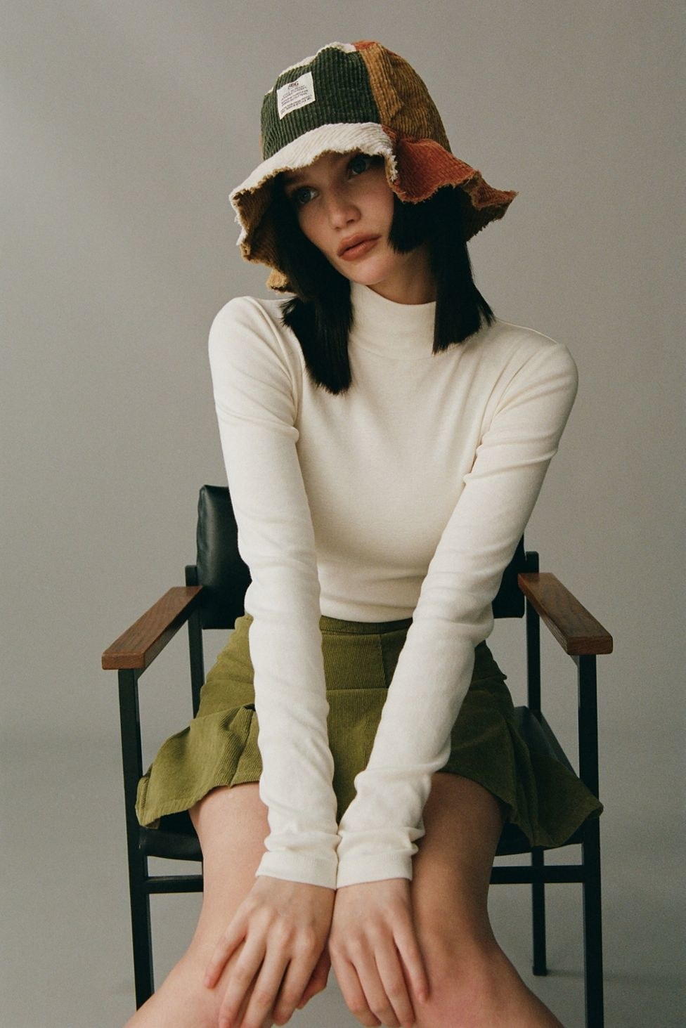model in a white long sleeve turtleneck sweater