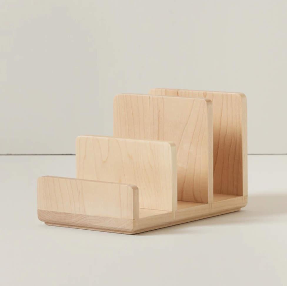 A wooden desktop file organizer with three sections