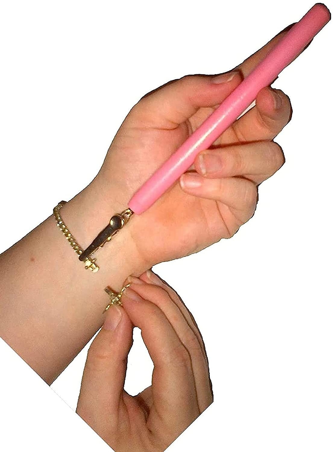 hands using the tool, a pink stick with clip on the end