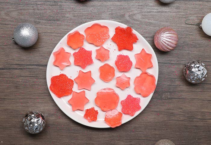 An overhead shot of a plate with Red Sparkling Dessert Bites on a plate in different shapes.