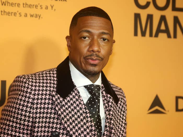 Nick Cannon in a houndstooth suit at a red carpet event