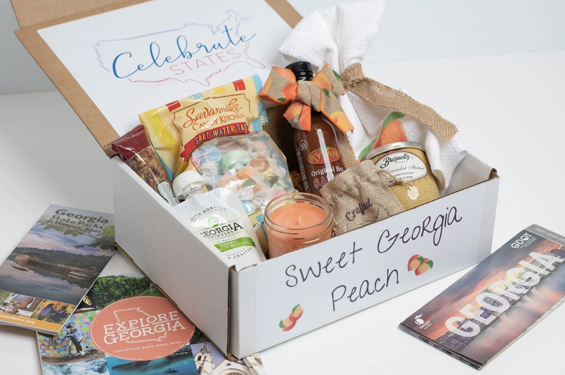 sweet georgia peach box filled with a candle, salt water taffy, peanut butter, and more goodies from georgia