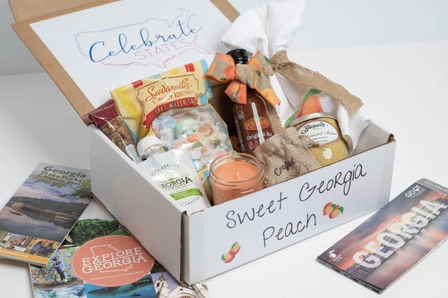 sweet georgia peach box filled with a candle, salt water taffy, peanut butter, and more goodies from georgia
