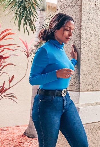 another reviewer wearing the blue turtleneck