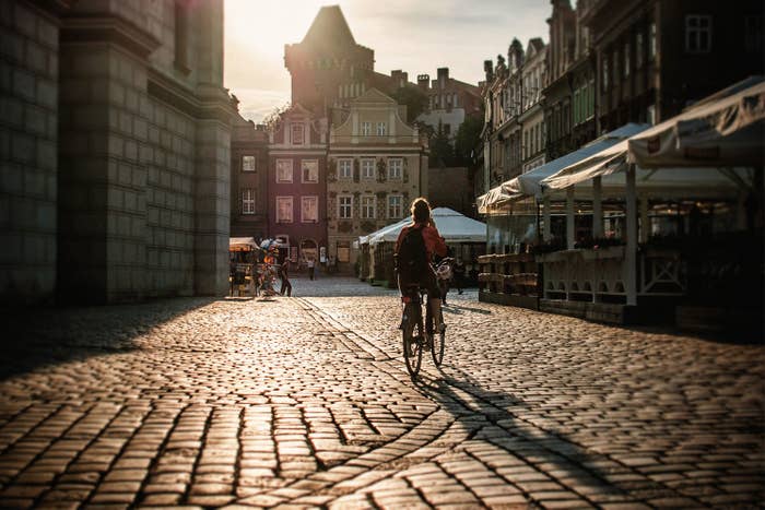 An empty street with a bicyle rider