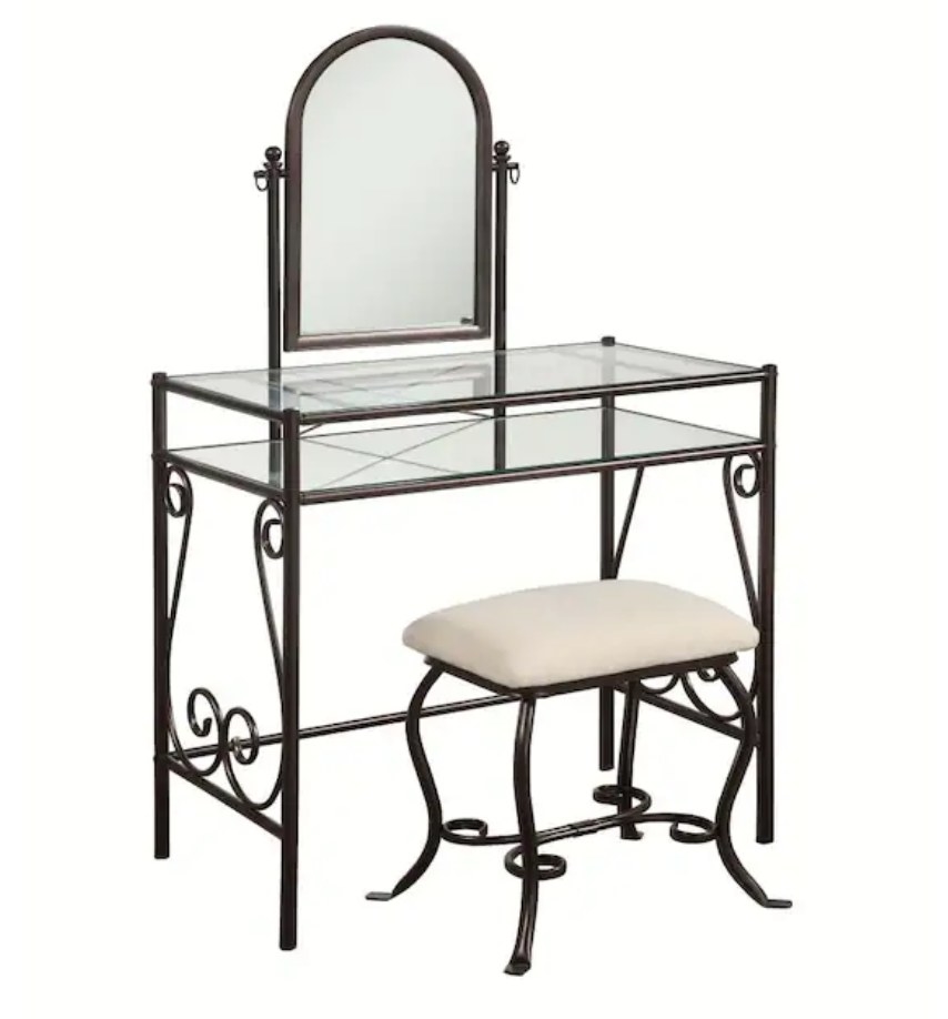 A metal makeup vanity with two shelves, one mirror, and a matching seat with a cream cushion