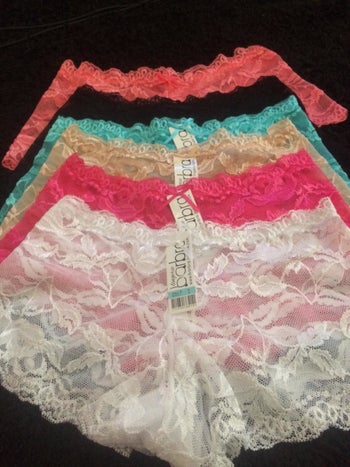 reviewer photo of different colored lace boyshorts laid out