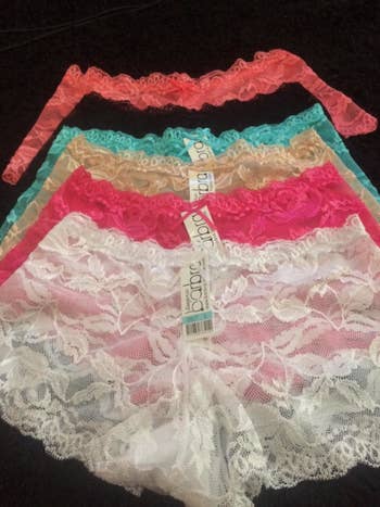 reviewer photo of different colored lace boyshorts laid out