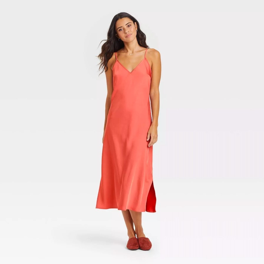 Model wearing coral slip dress