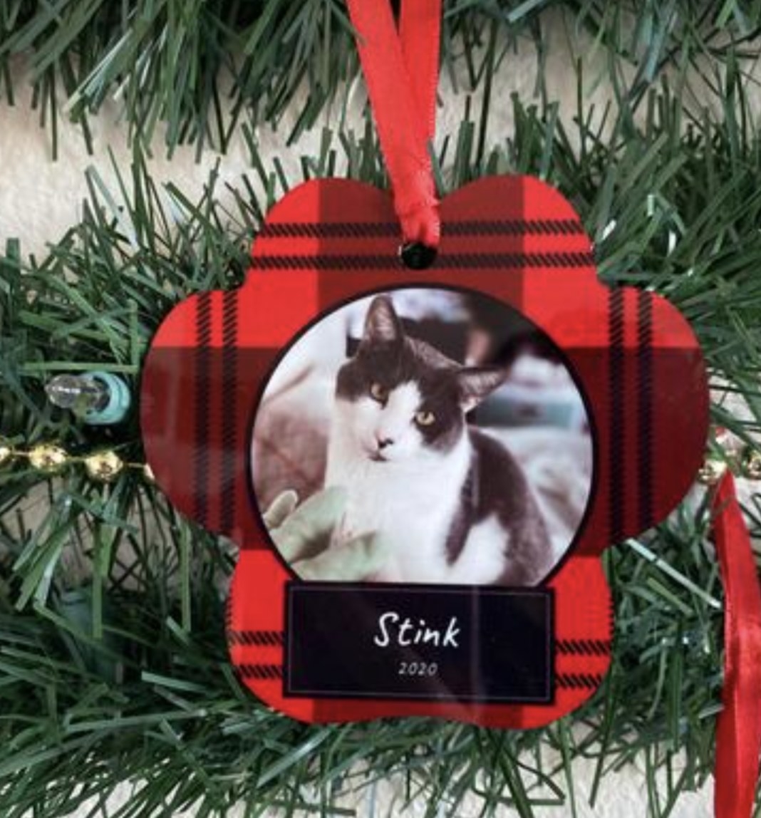 a plaid ornament with a photo of a cat with its name and birth year written underneath