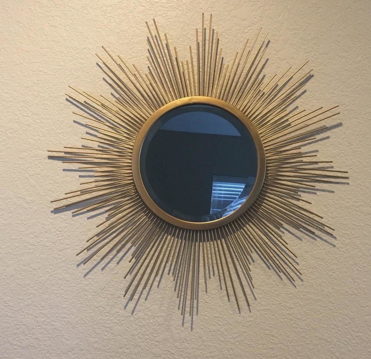 the starburst mirror on a wall