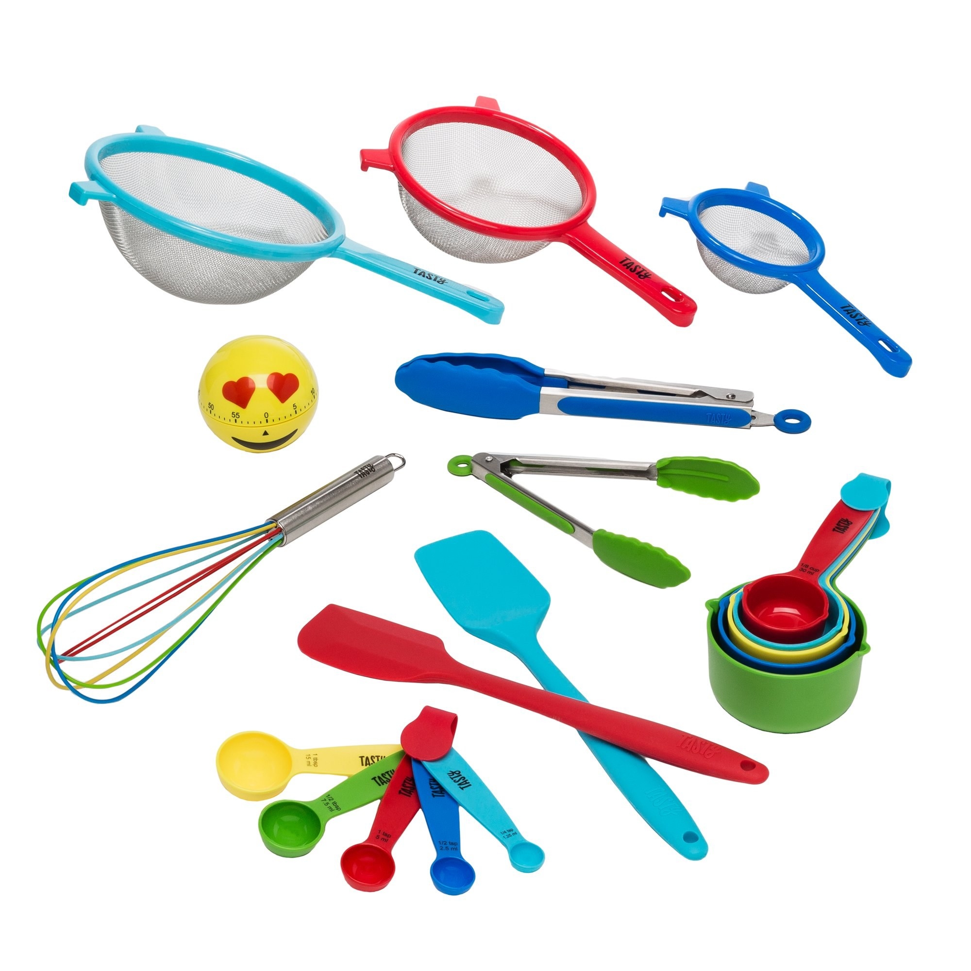 Three strainers of varying colors and sizes, a heart-eyes emoji timer, measuring spoons splayed out but connected at their handle, stacked measuring cups, one red spatula crossed over a second blue spatula, one whisk with multicolor prongs, two tongs