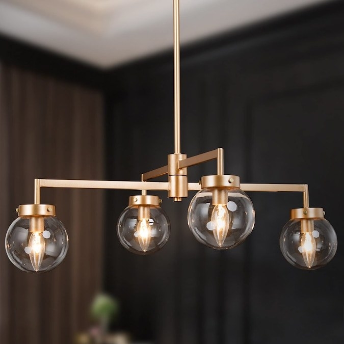 gold pendant light with two crossing bars and four clear globe light shades