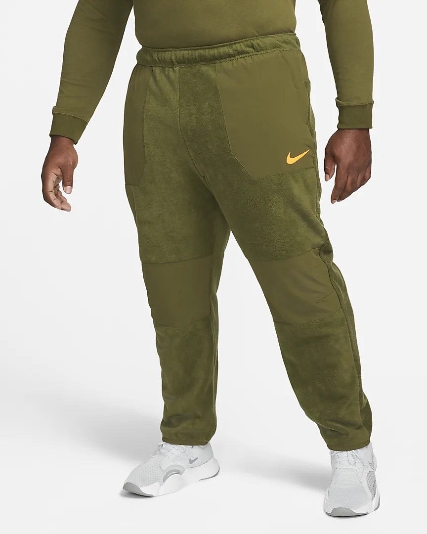 Model wearing army green texture pants and a matching top  with white shoes