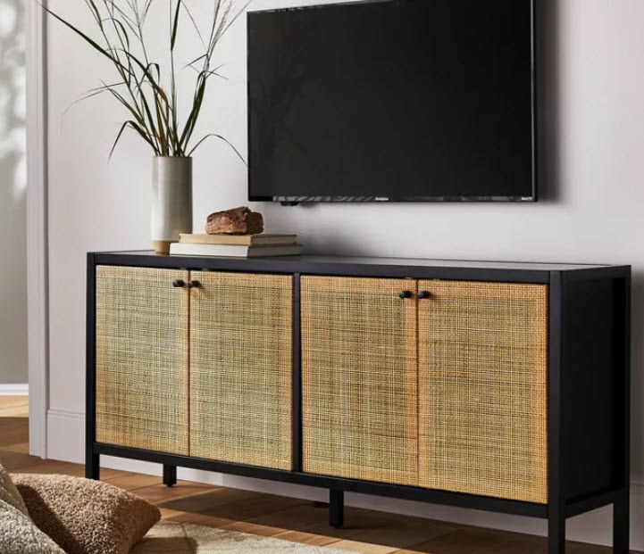 A solid black wooden frame TV stand with cane-front double doors for maximum storage space and even cooler design. Small black pulls for handles keep the piece simple and elegant.