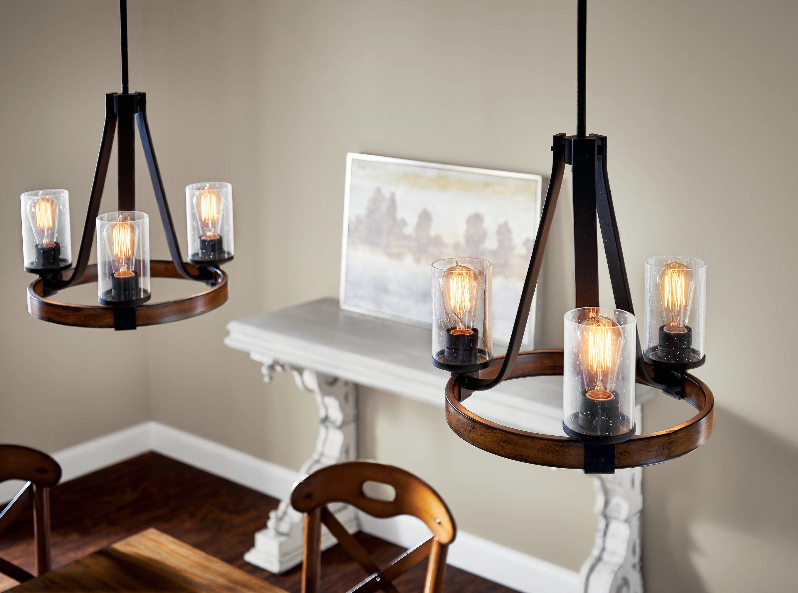 two black and wood chandeliers