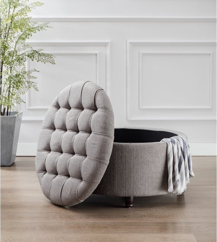 The tufted round fabric ottoman in gray
