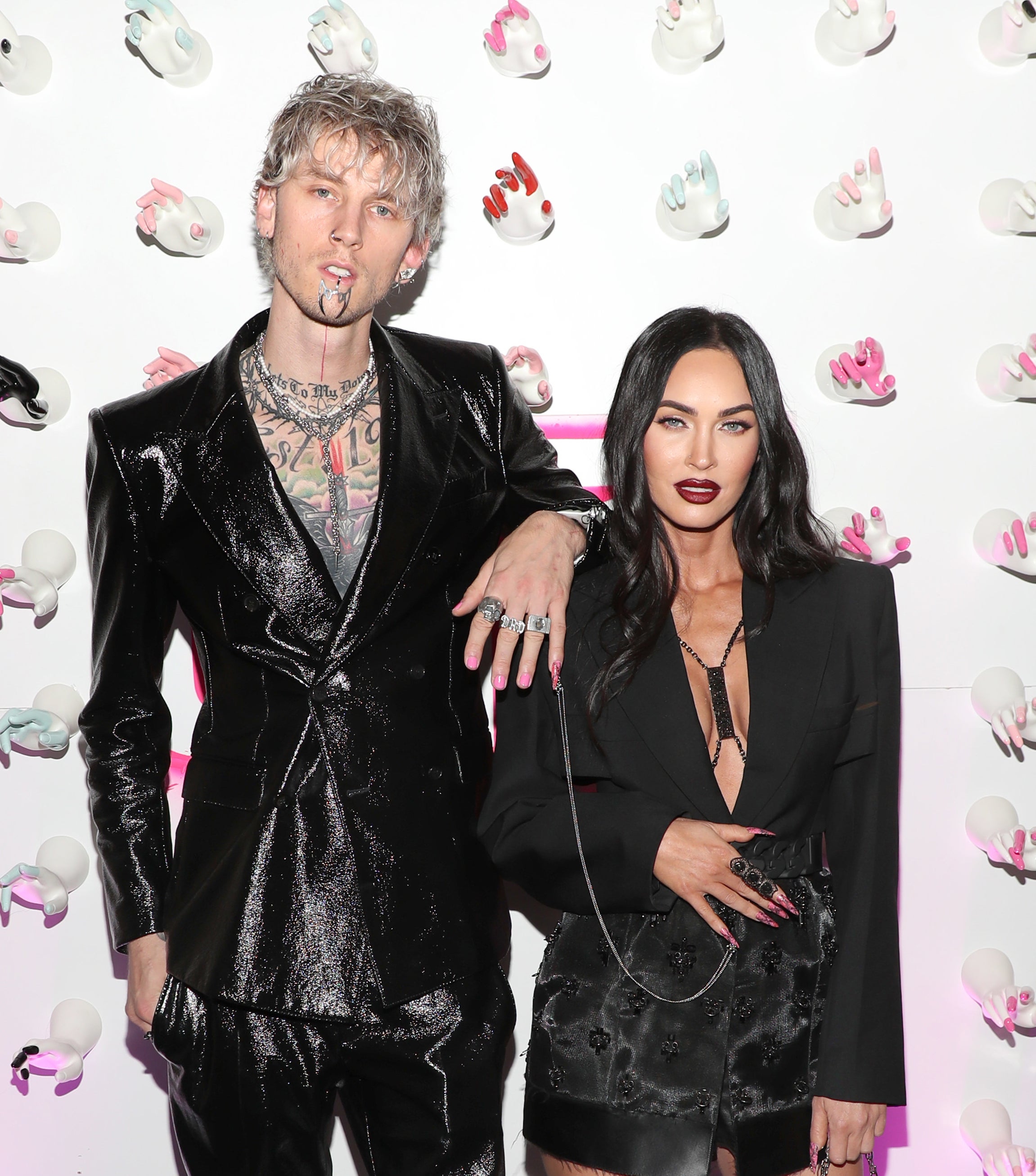 Machine Gun Kelly rests his arm on Megan&#x27;s shoulder and shows off nail chain
