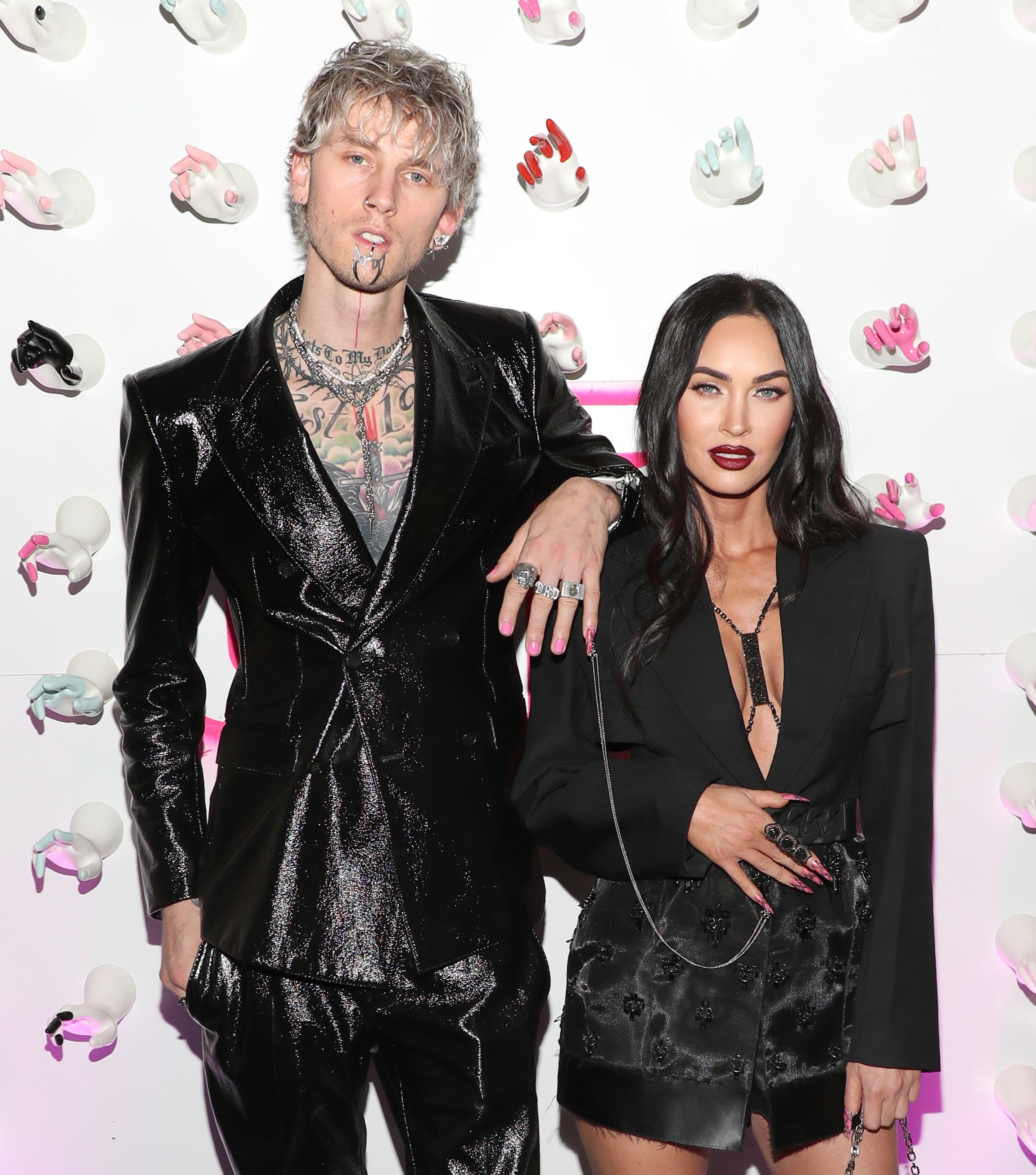 Machine Gun Kelly rests his arm on Megan&#x27;s shoulder and shows off nail chain