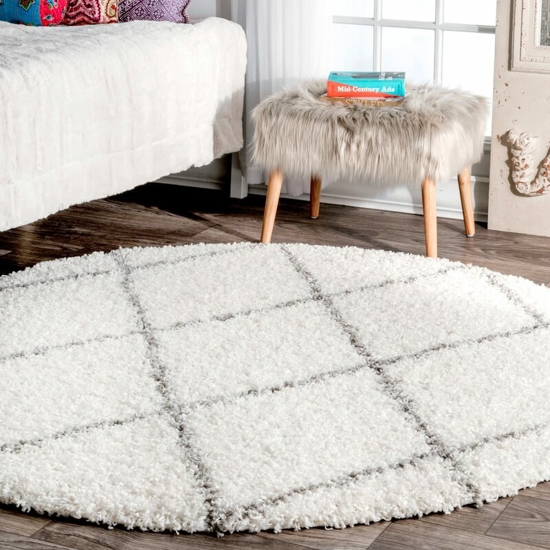 The circular shag rug in white with gray crisscross pattern