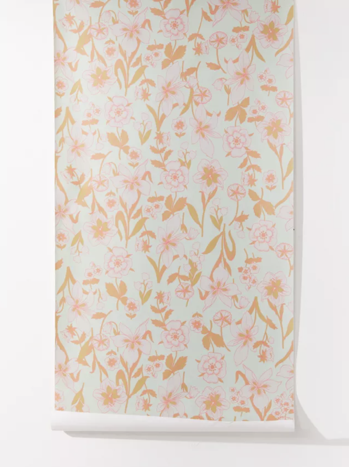 Mint green wallpaper with pink and orange flowers hung on white wall