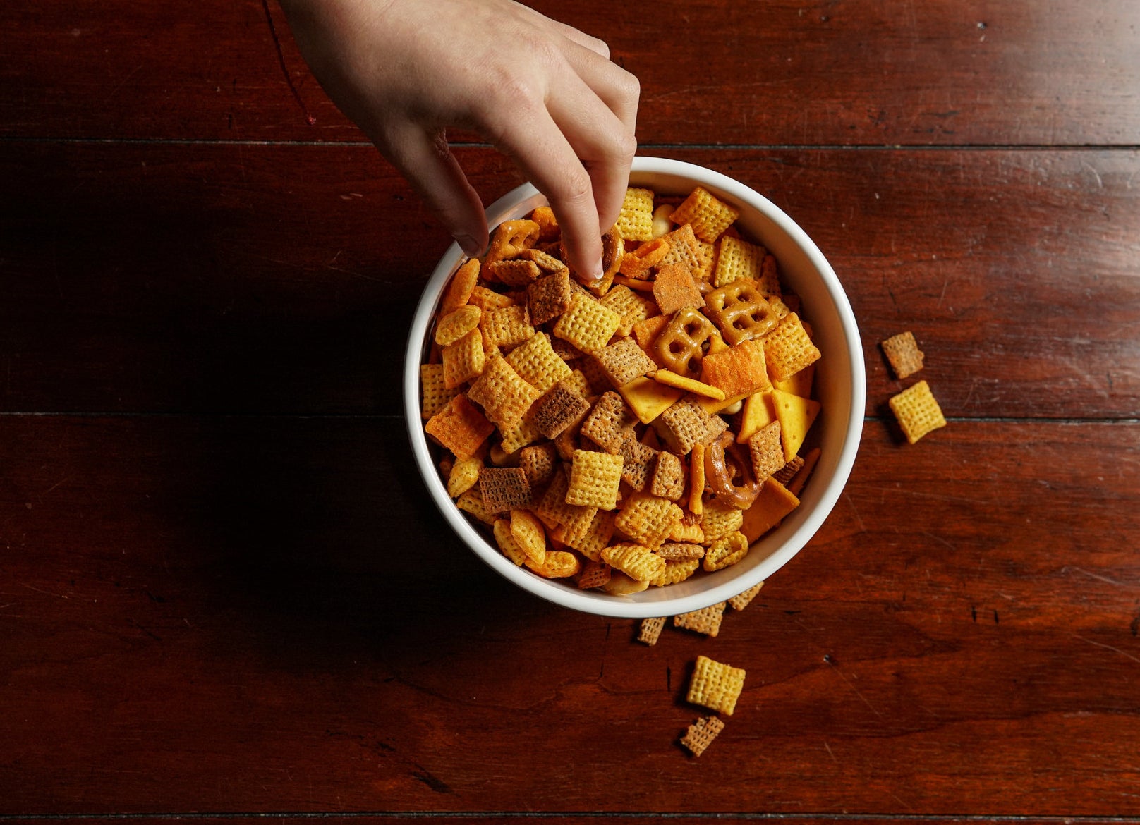 Reaching into a snack bowl.