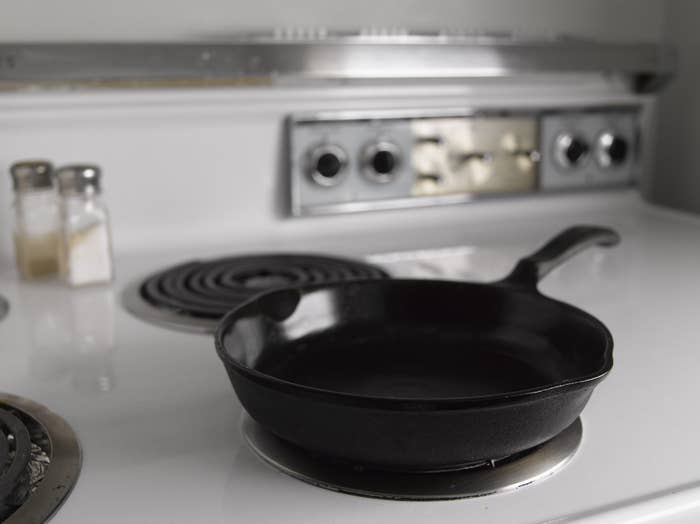 A clean cast iron skillet on the stovetop.