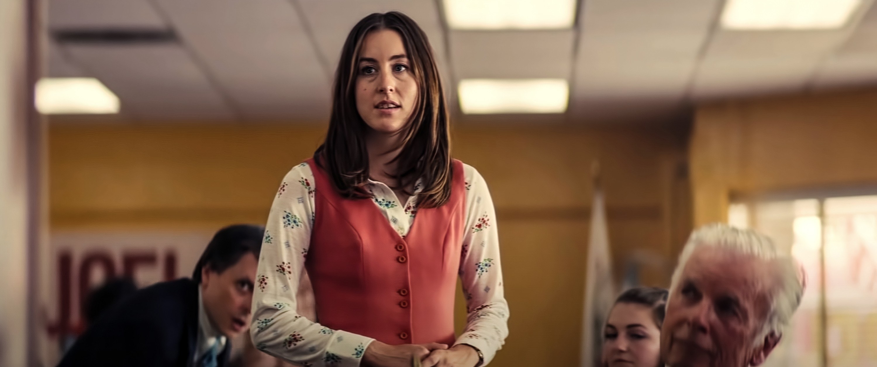 Alana Haim stands in an political office