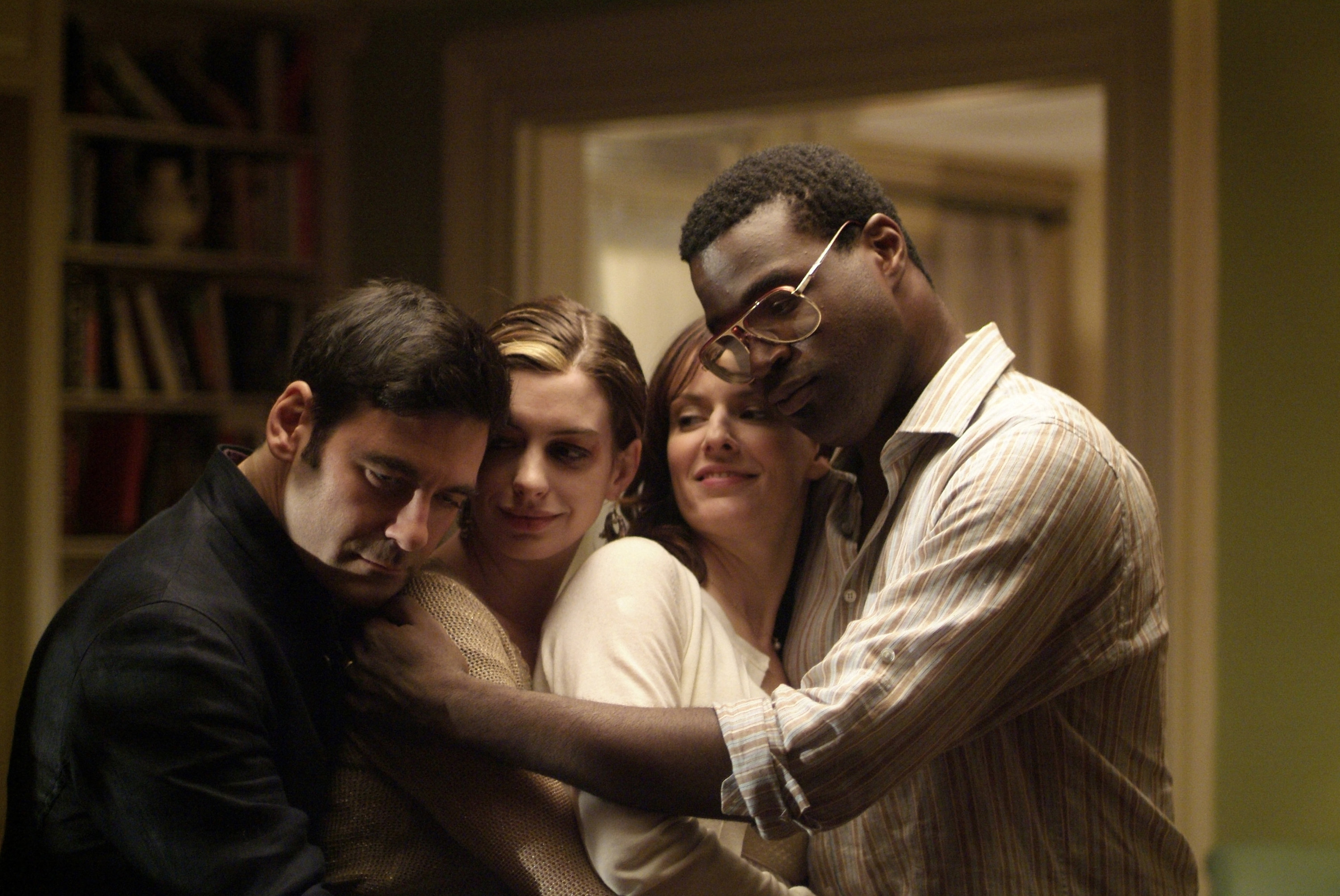 Mather Zickel, Anne Hathaway, Rosemarie DeWitt, and Tunde Adebimpe embrace