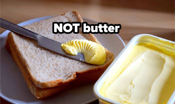 Spreading margarine on bread.