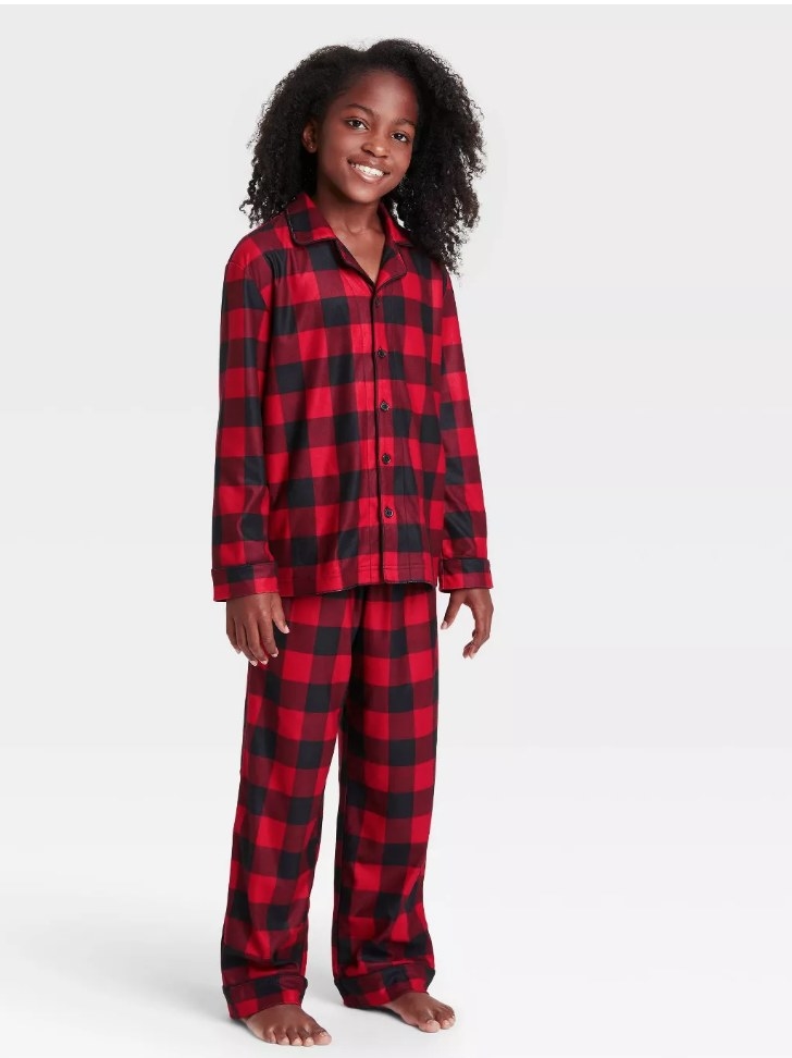 Model wearing black and red plaid flannel long sleeve/long pant pajama set