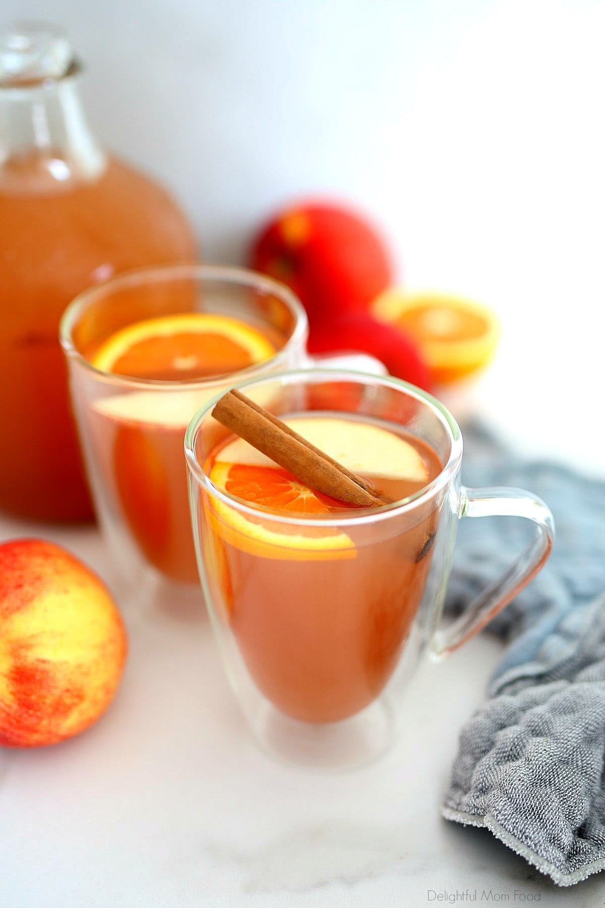 apple cider in cups with cinnamon sticks