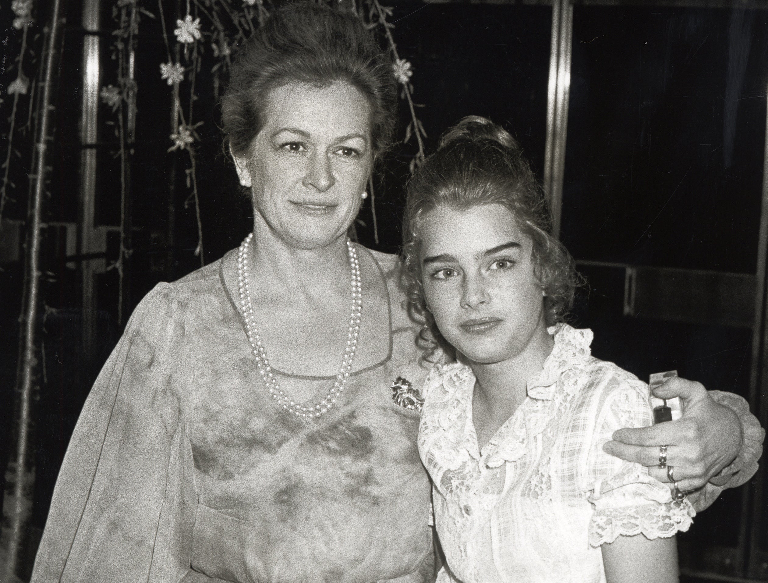 Brooke looks uncertain while posing for a photo with her mom as a teen