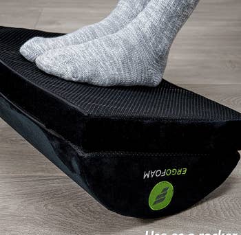 The footrest flipped over with a model resting their feet on the flat side of the footrest
