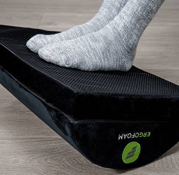 the foot rest flipped over with a model resting their feet on the flat side of the foot rest