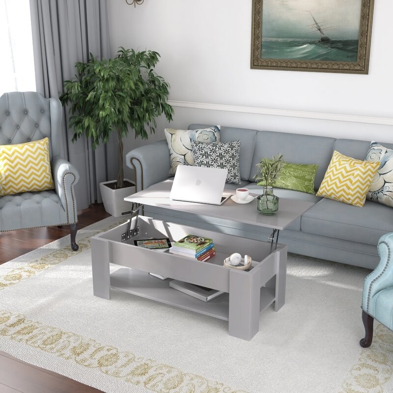 The coffee table in gray with a liftable surface