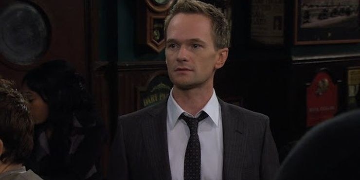 barney wears a suit and tie, emotionless relaxed face