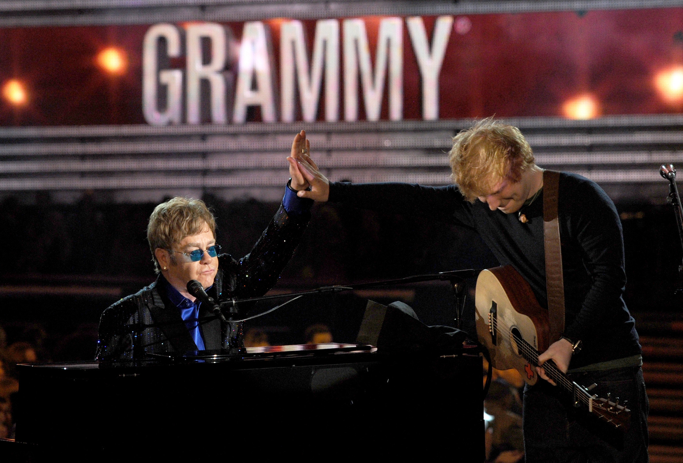 Sheeran and John give each other a high five onstage