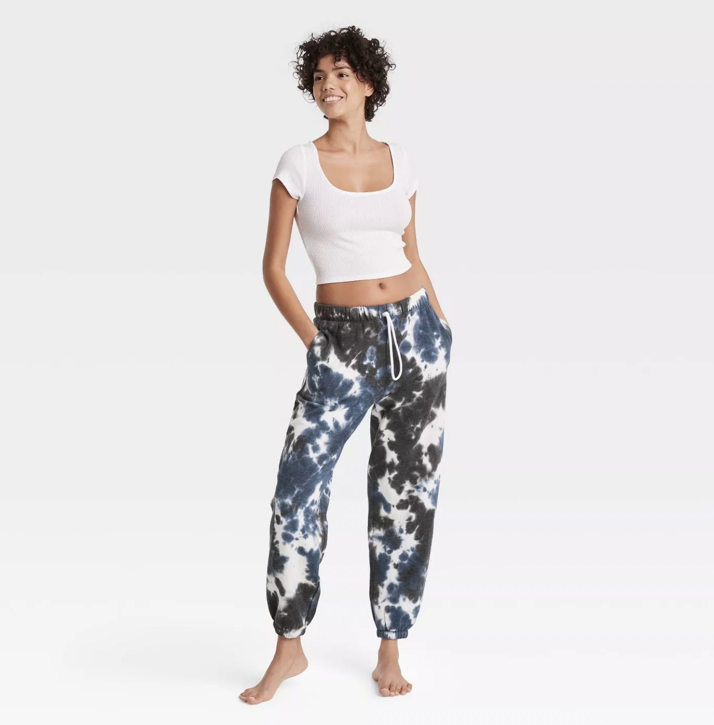 Model wearing the blue and white tie-dye joggers with fold-over elastic waist