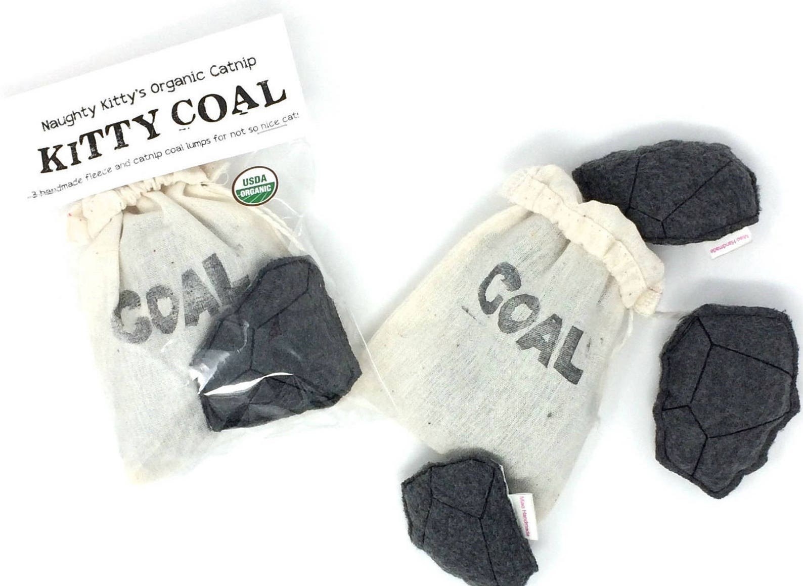 four pieces of coal and a canvas bag that says &quot;coal&quot;