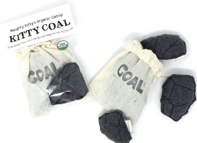four pieces of coal and a canvas bag that says 