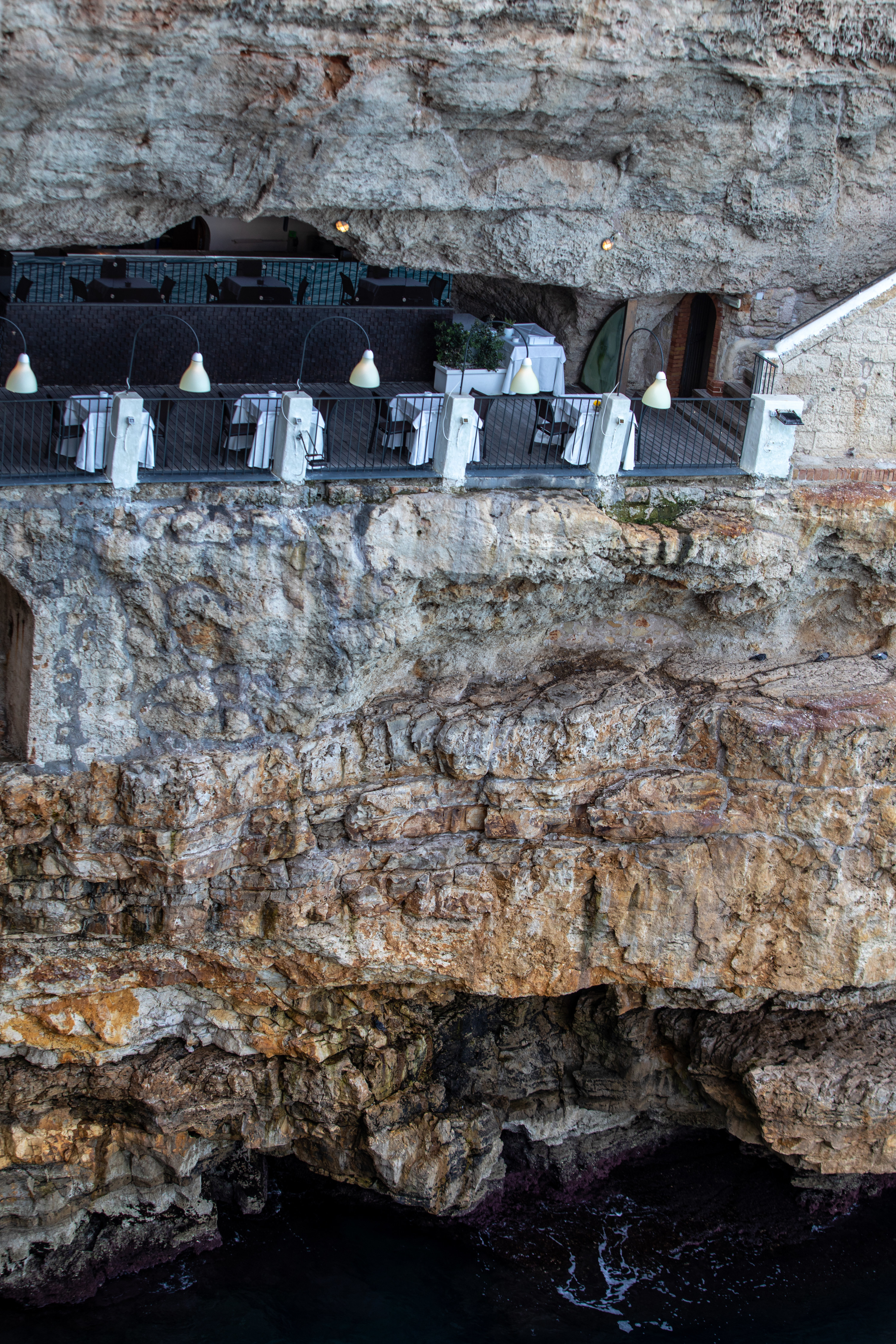 Grotta Palazzese restaurant, set in a cave in the cliffs at Polignano a Mare, Puglia, Italy