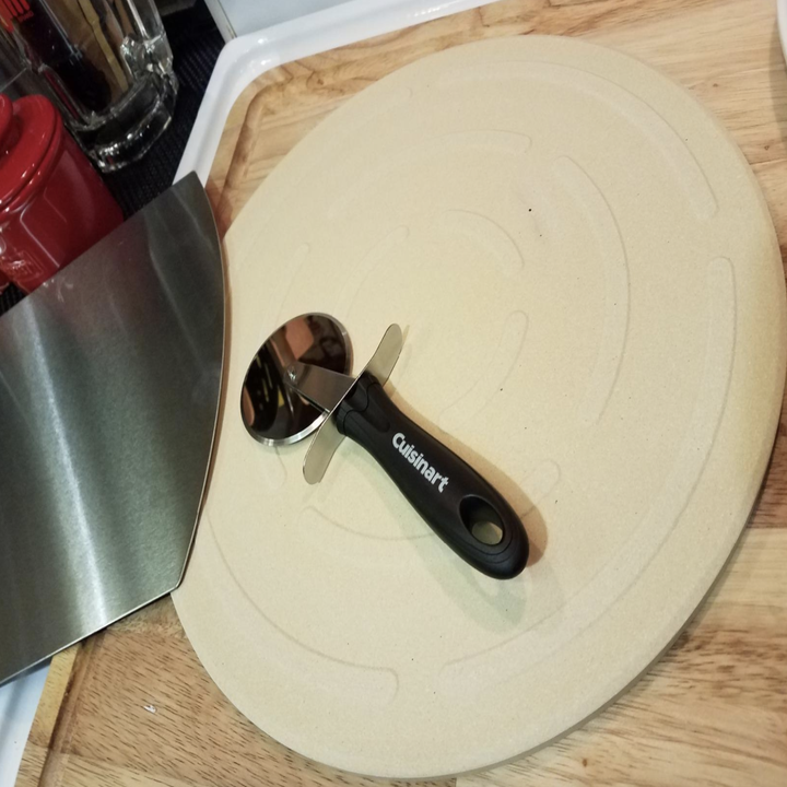 A customer review photo of them putting a pizza in their oven