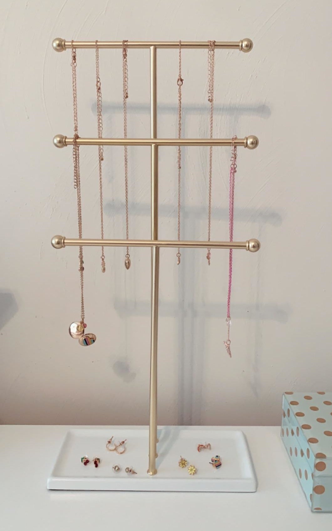 Reviewer photo of the white and brass jewelry stand