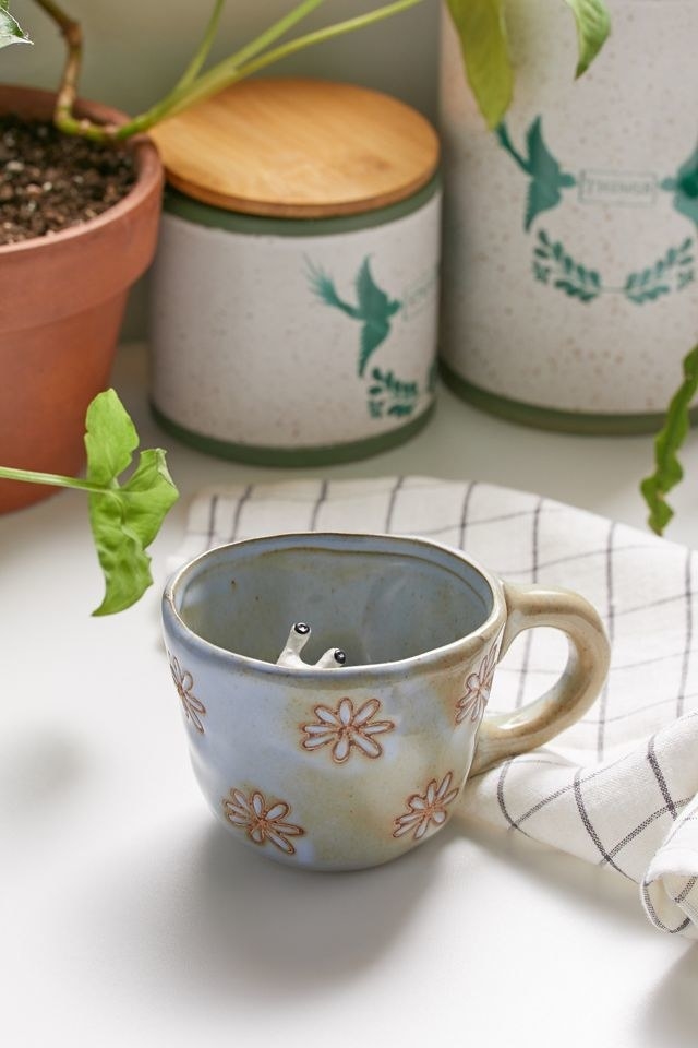 Floral ceramic mug with a snail inside