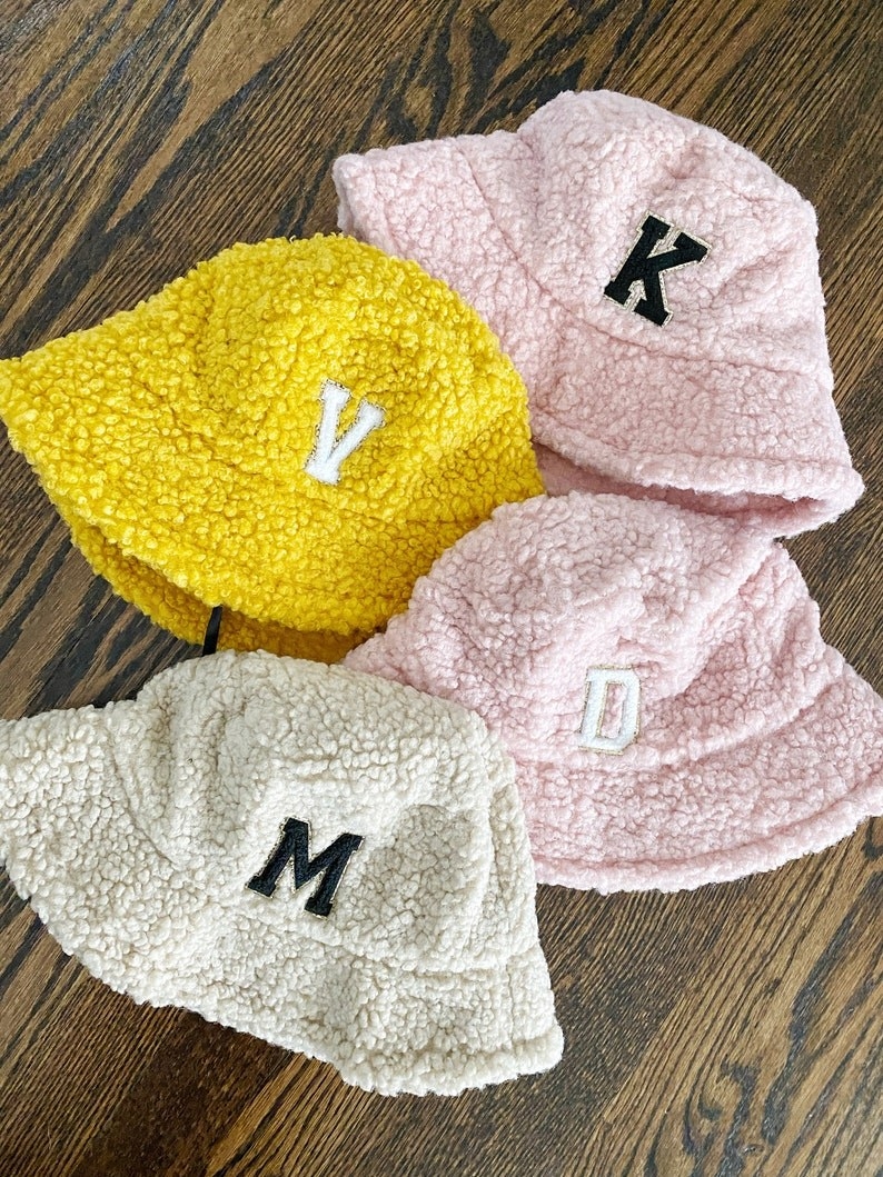 fuzzy sherpa bucket hats in yellow, pink, and tan
