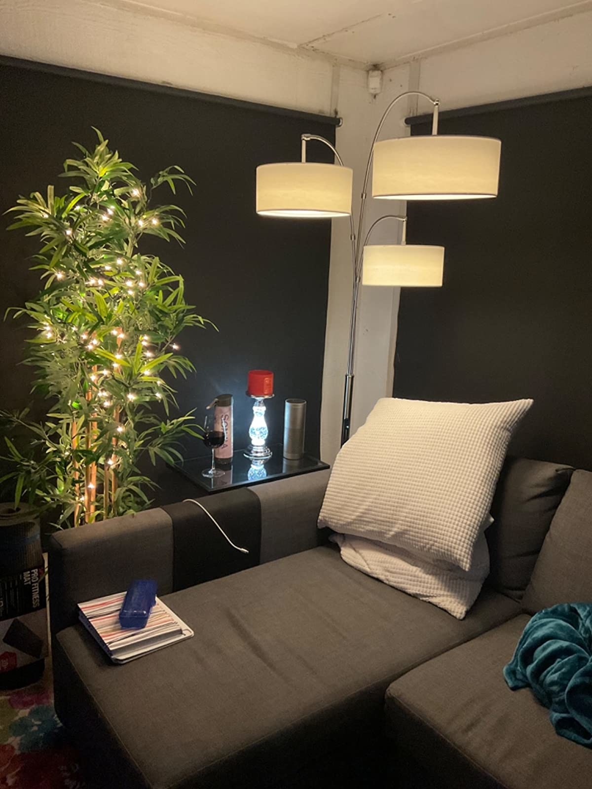 A reviewer&#x27;s space with the three-arc smart lamp in the corner