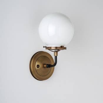 A white glass wall sconce